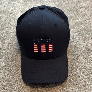 Travis Matthew Navy Baseball Cap with American Flag “M” Patch